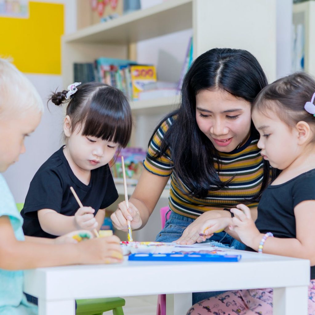 Teacher is teaching kids in daycare